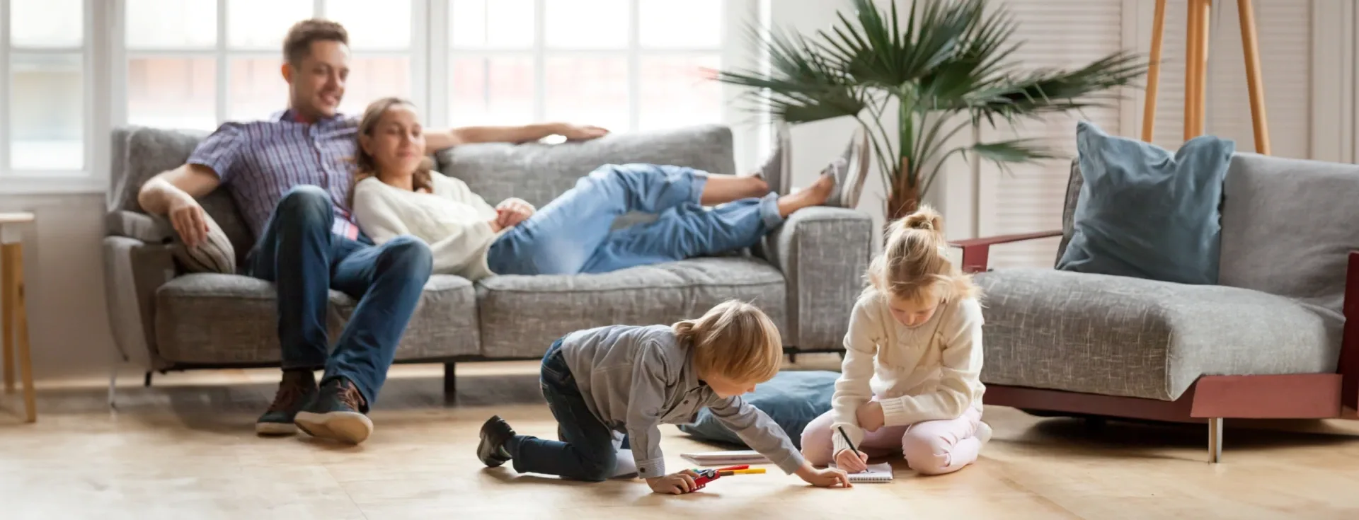 Happy family relaxing on couch, symbolizing home comfort from Made Simple Heating & Air.