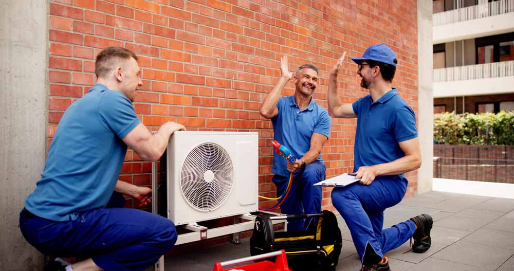 Close-up of new HVAC tech on display with people in the background.